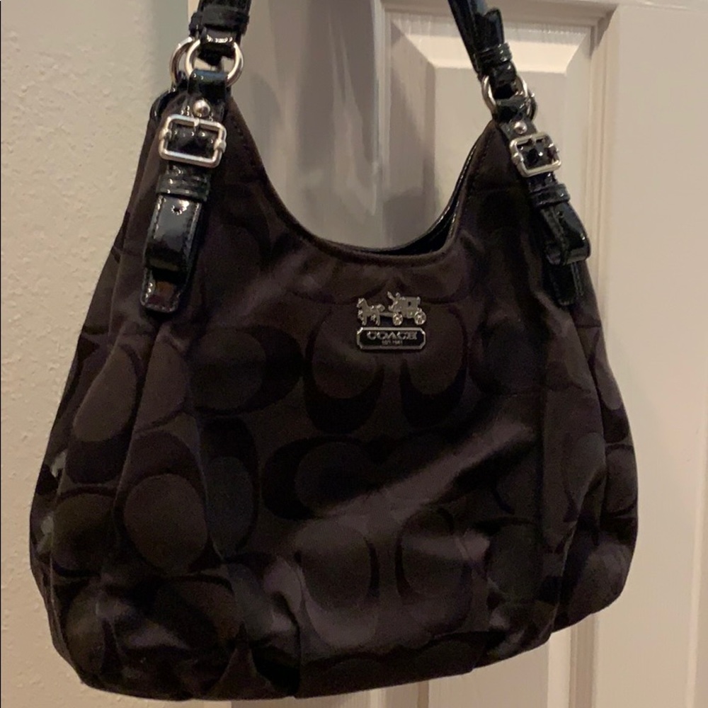 Black, coach purse with burgundy lining